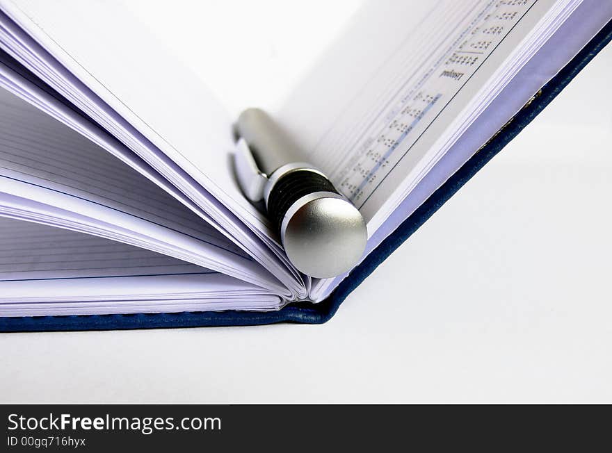 Open day planner with a silver pen. Open day planner with a silver pen.