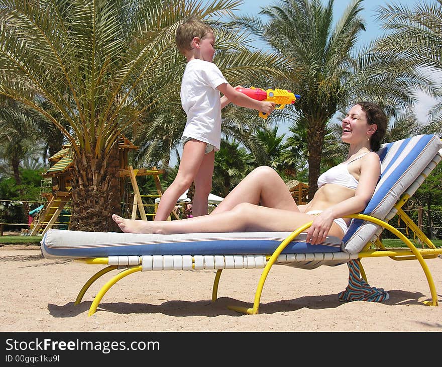 Mother With Child On A Beach