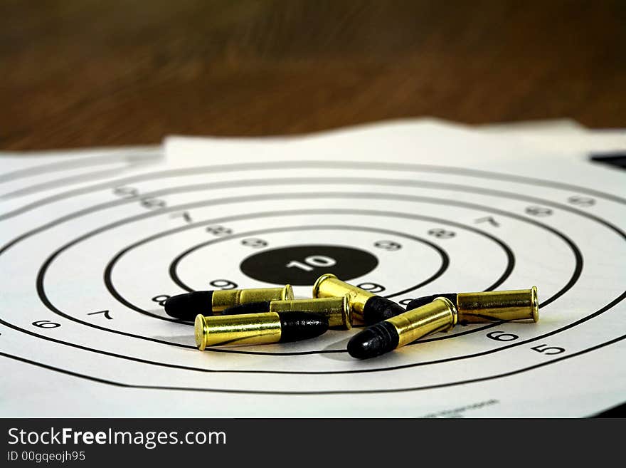 Several cartridges and targets on a table in studio, (halogen light). Several cartridges and targets on a table in studio, (halogen light).