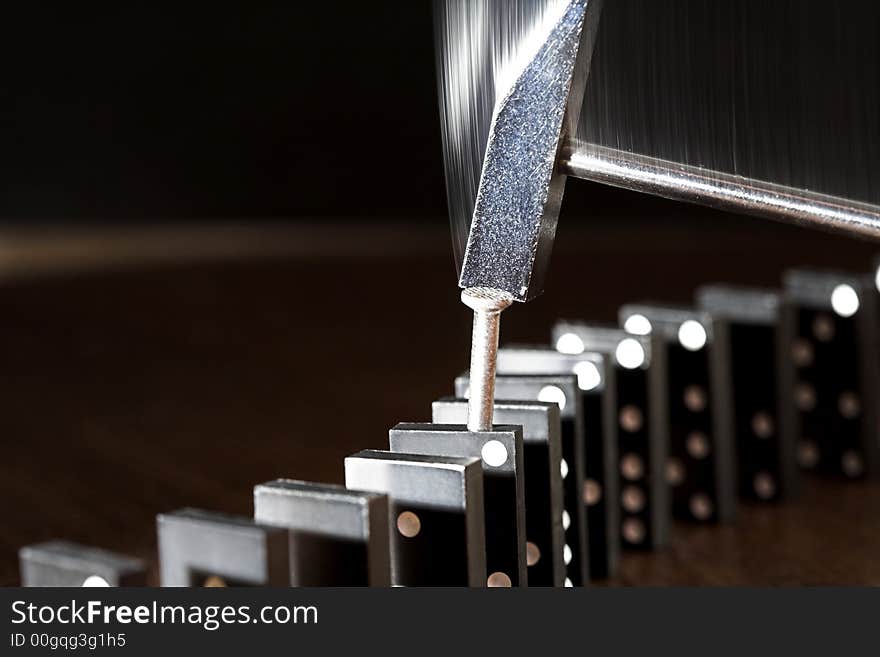 Nail, hammer and row of dominoes on a table, (studio, halogen light and flash). Nail, hammer and row of dominoes on a table, (studio, halogen light and flash).