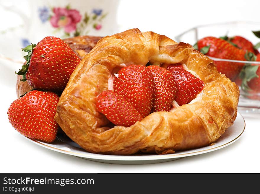 Beautiful Strawberry pastry with fresh fruit and a cup of tea. Beautiful Strawberry pastry with fresh fruit and a cup of tea.