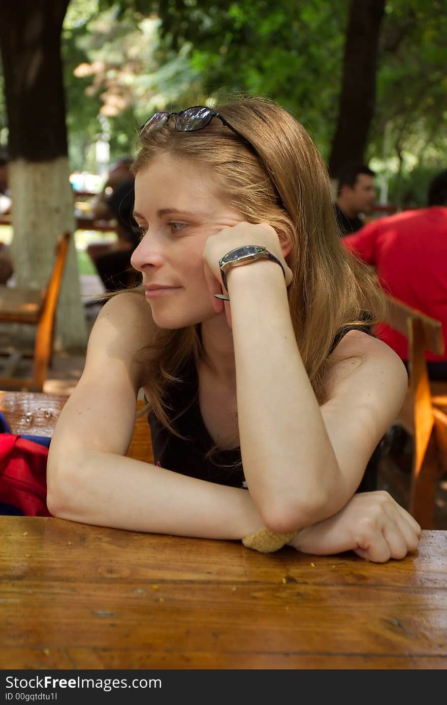 Beautiful blond woman thinking to something at the table. Beautiful blond woman thinking to something at the table