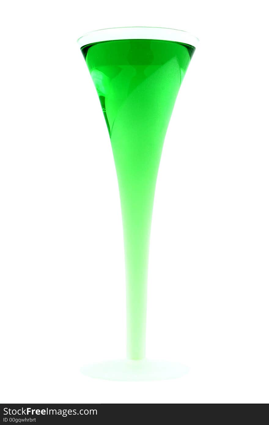 Green drink in a stylish glass on a white background