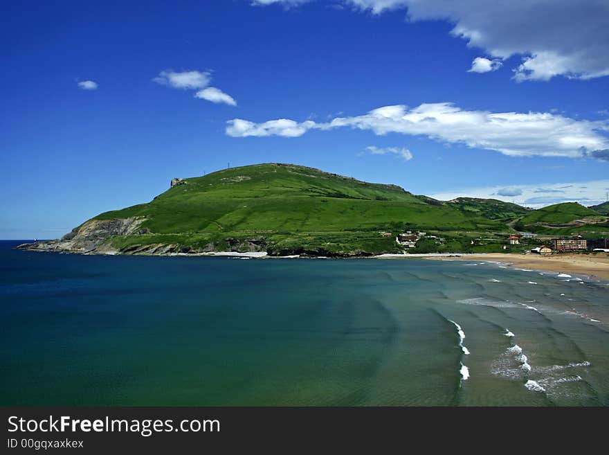 A seascape of a beautiful beach and a hill. A seascape of a beautiful beach and a hill.