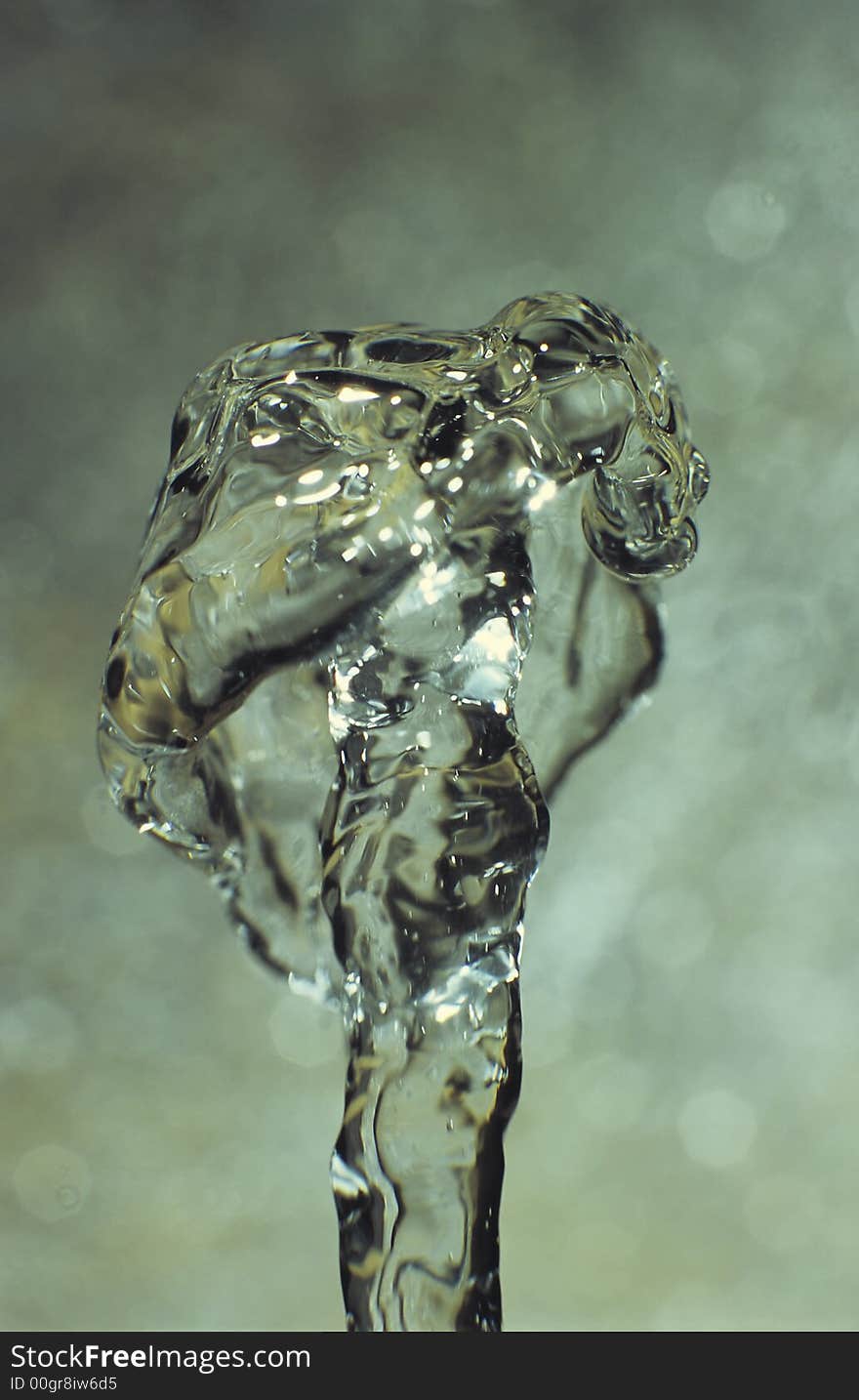 Water coloumn produced by a small table fountain, frozen by flash-light. Water coloumn produced by a small table fountain, frozen by flash-light.