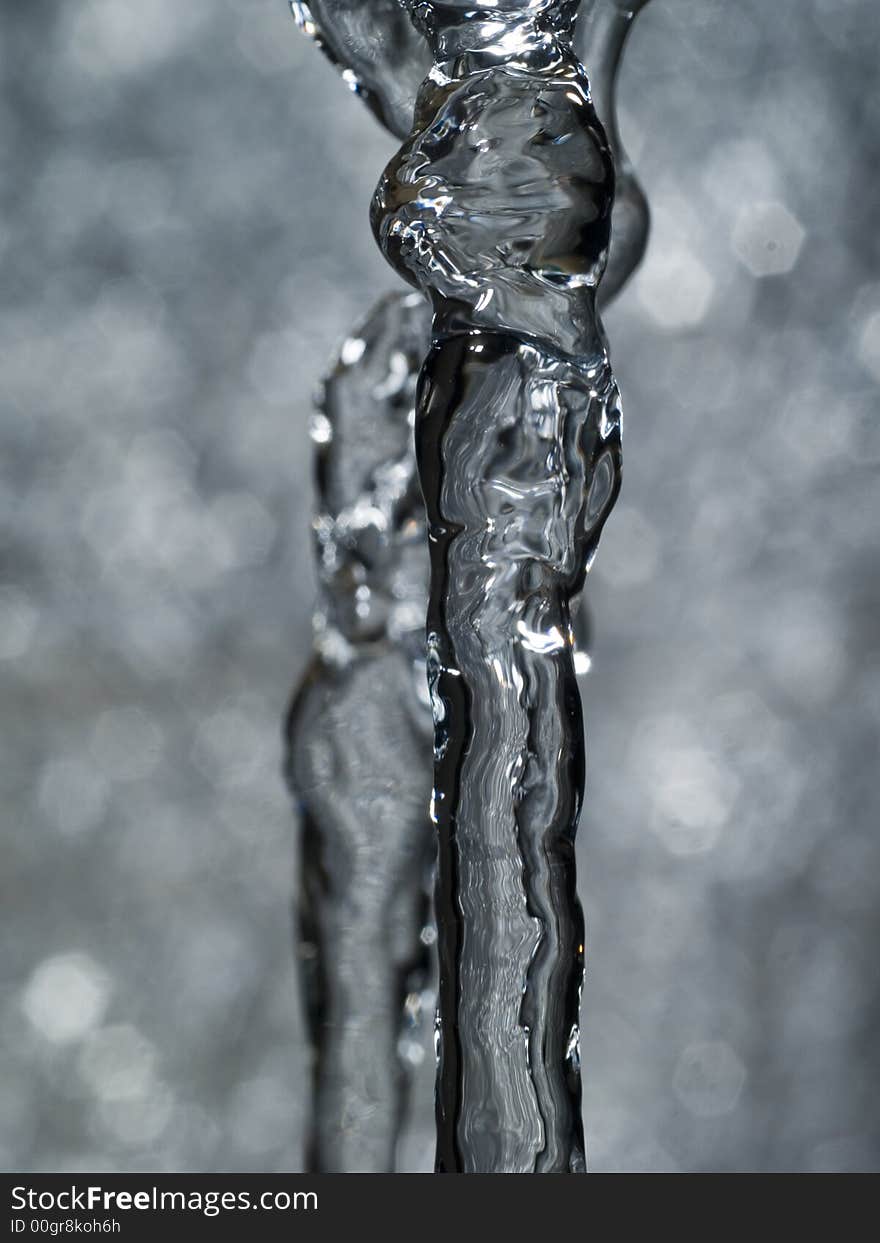 Water coloumn produced by a small table fountain, frozen by flash-light. Water coloumn produced by a small table fountain, frozen by flash-light.