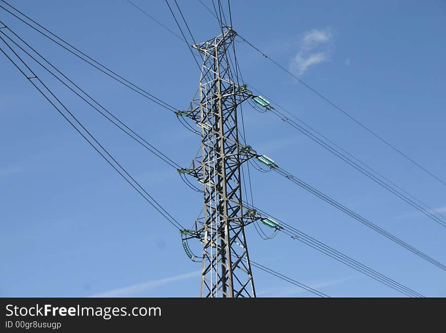 Glance from the ground level up at the electricity pole and wires