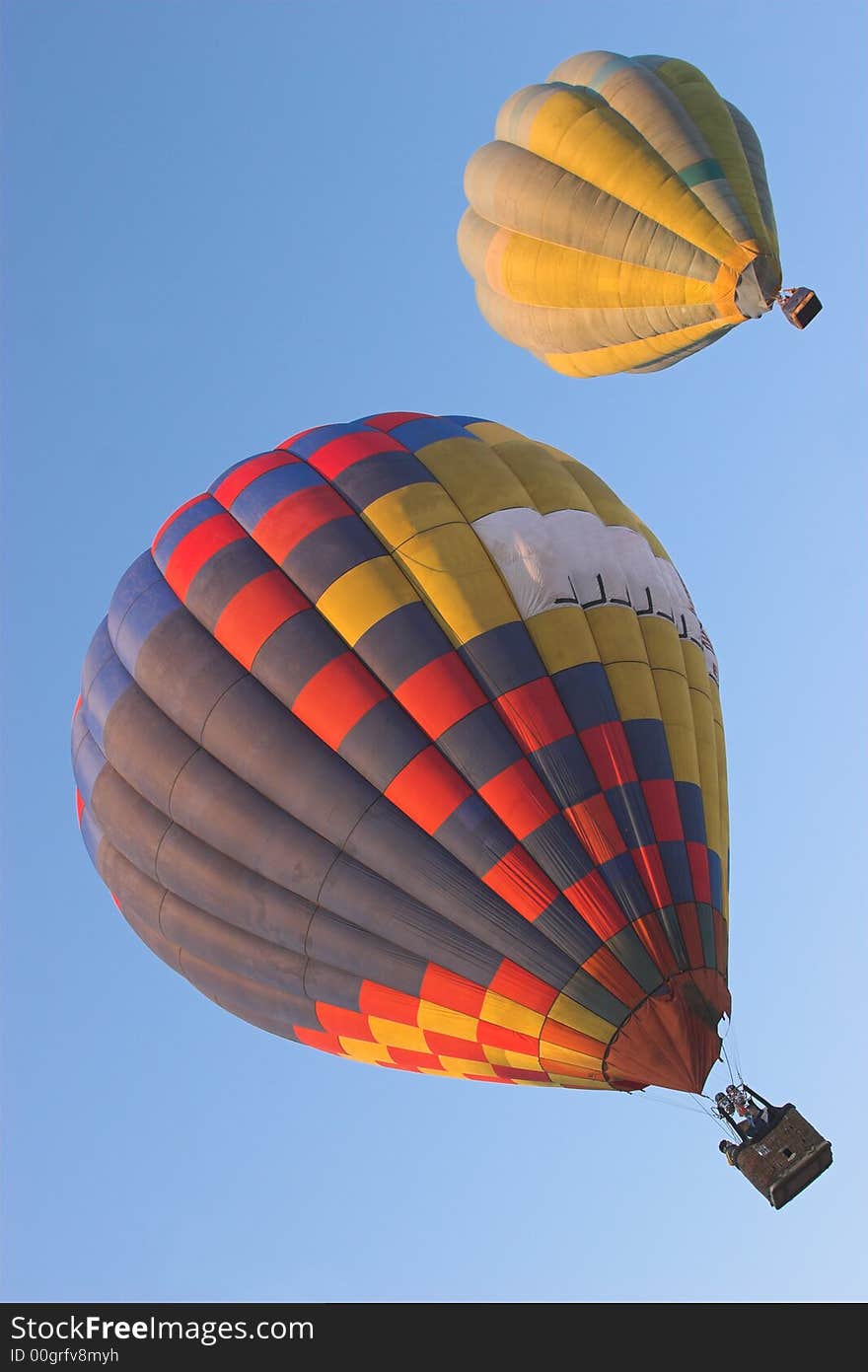 Two hot air balloons flying side by side. Two hot air balloons flying side by side