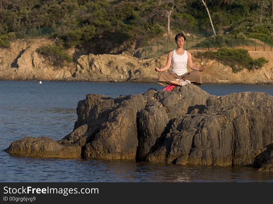 Woman making of yoga at the seaside. Woman making of yoga at the seaside