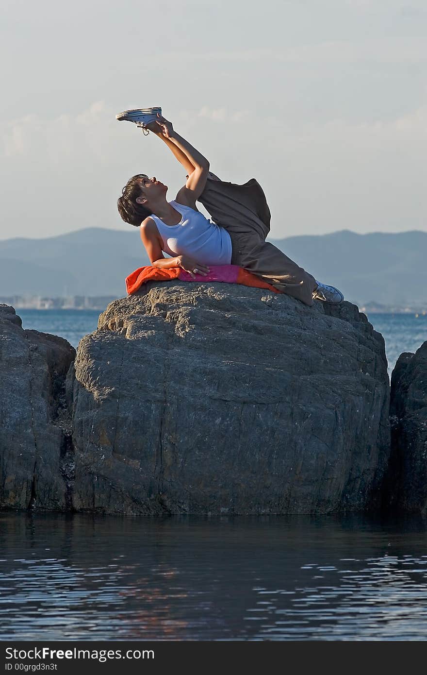 Woman making a exercise of stretching at the seaside. Woman making a exercise of stretching at the seaside