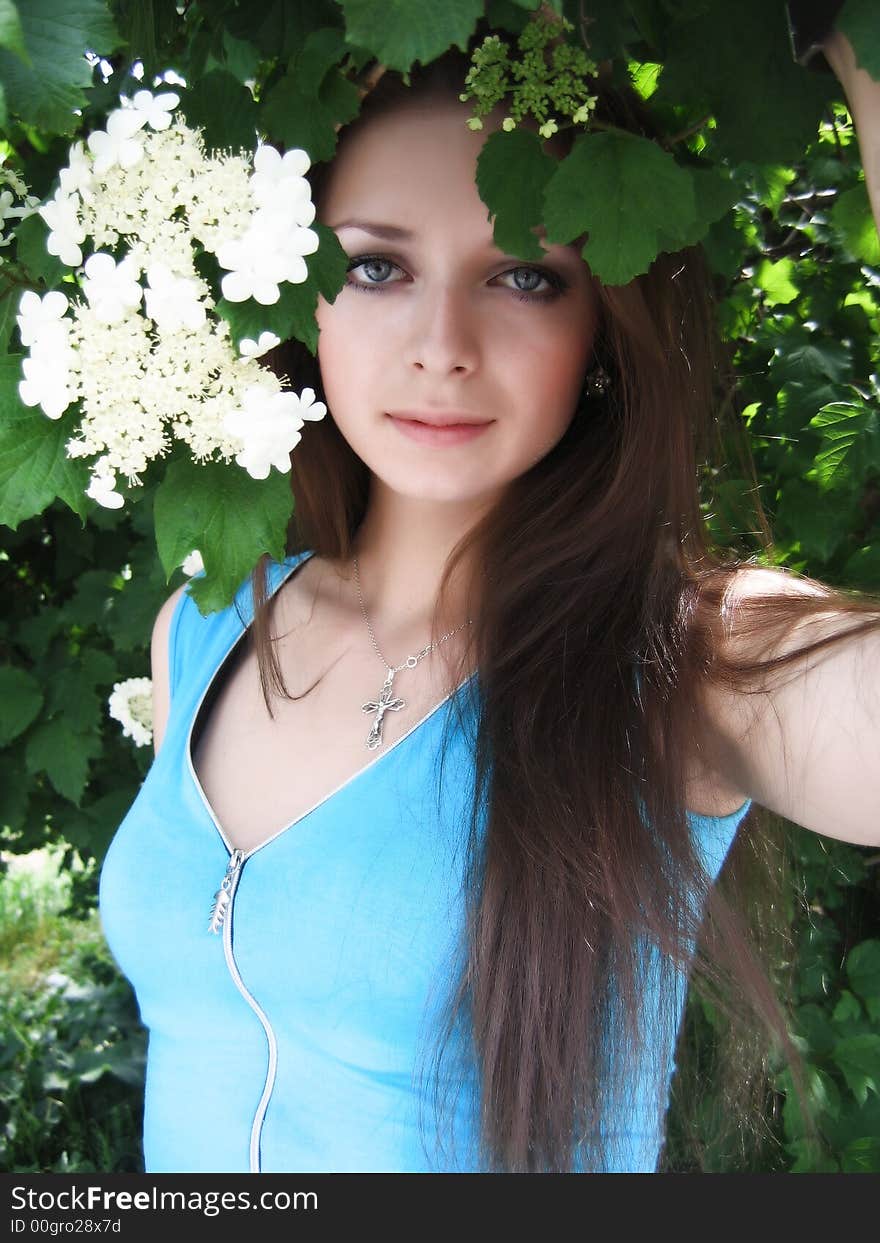 Long-haired beautiful girl in white flower blossom. Long-haired beautiful girl in white flower blossom