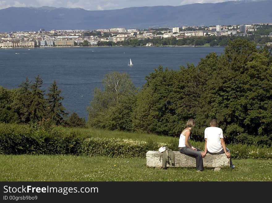 A young couple enjoying the view of lake Geneva. A young couple enjoying the view of lake Geneva