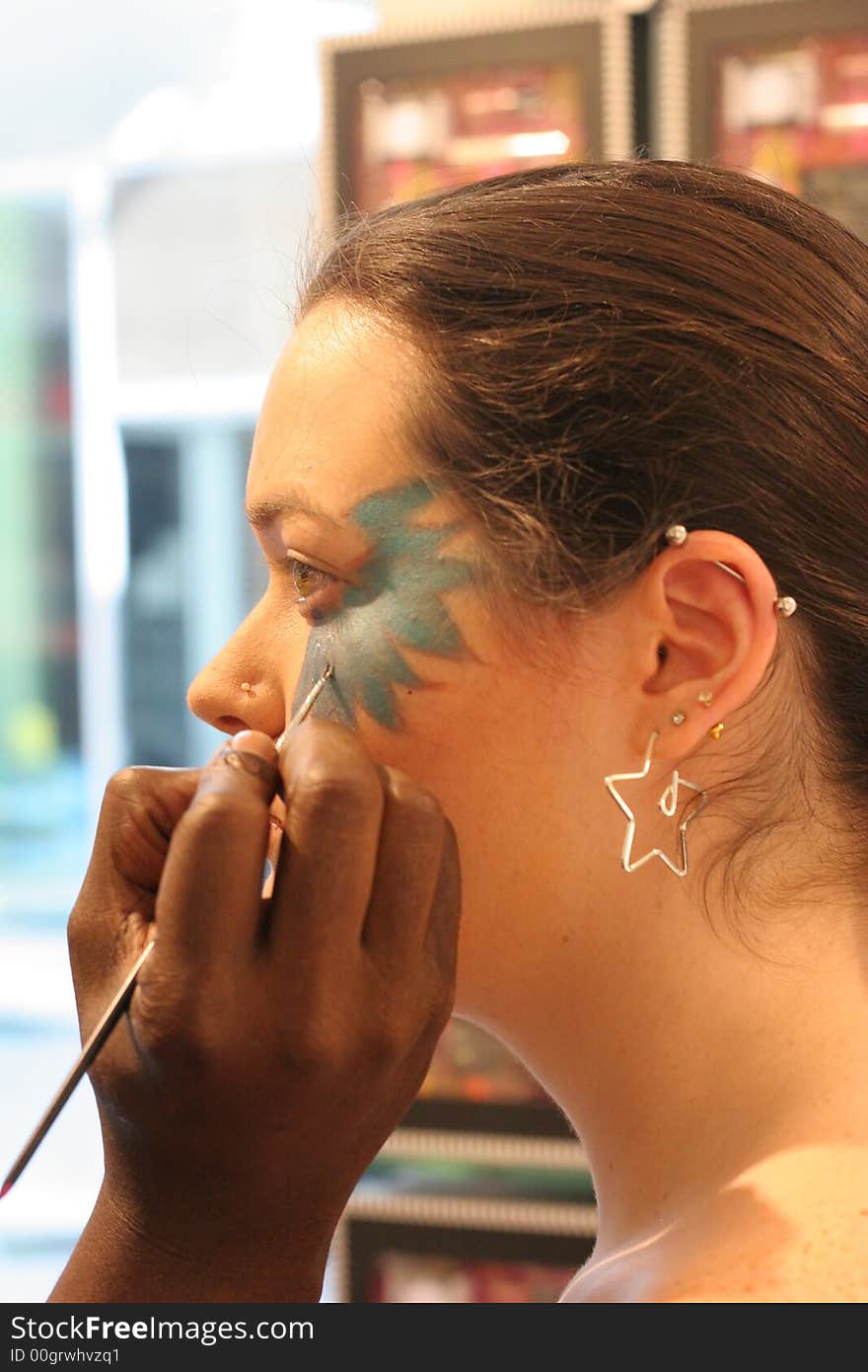 Model having makeup applied at a mall store. Model having makeup applied at a mall store