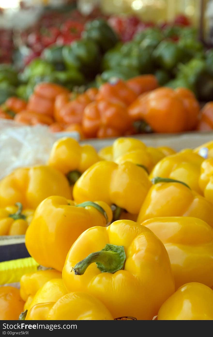 Ripe yellow peppers on display.