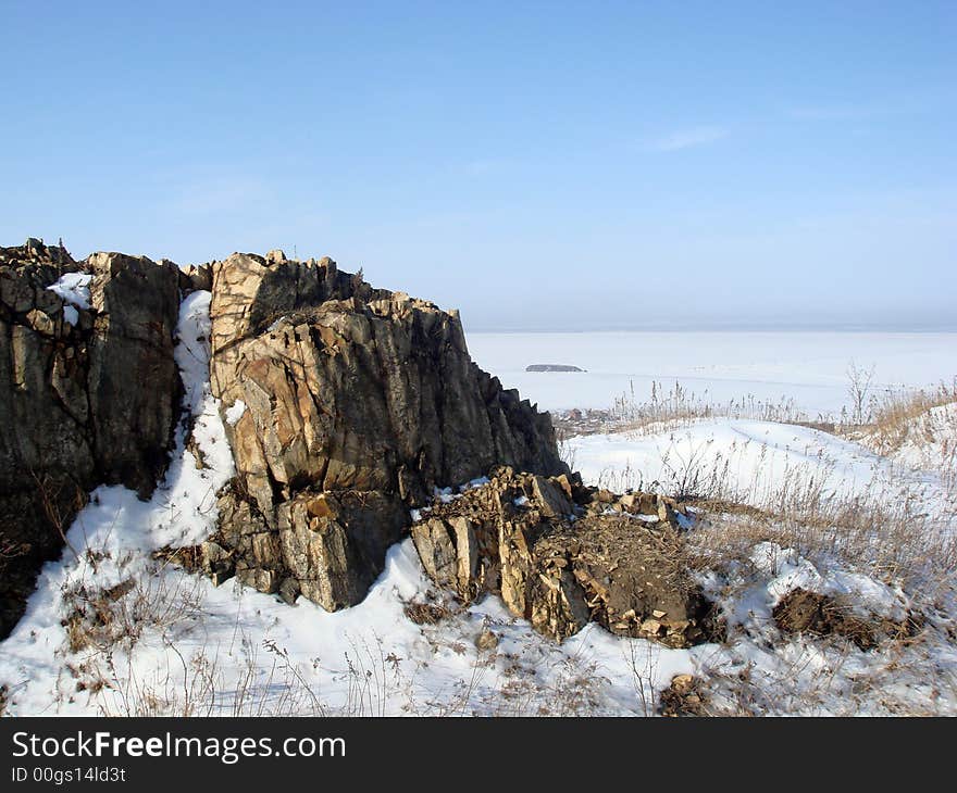 Rock in snow near fort and island Kovrizhka, Vladivostok. Rock in snow near fort and island Kovrizhka, Vladivostok