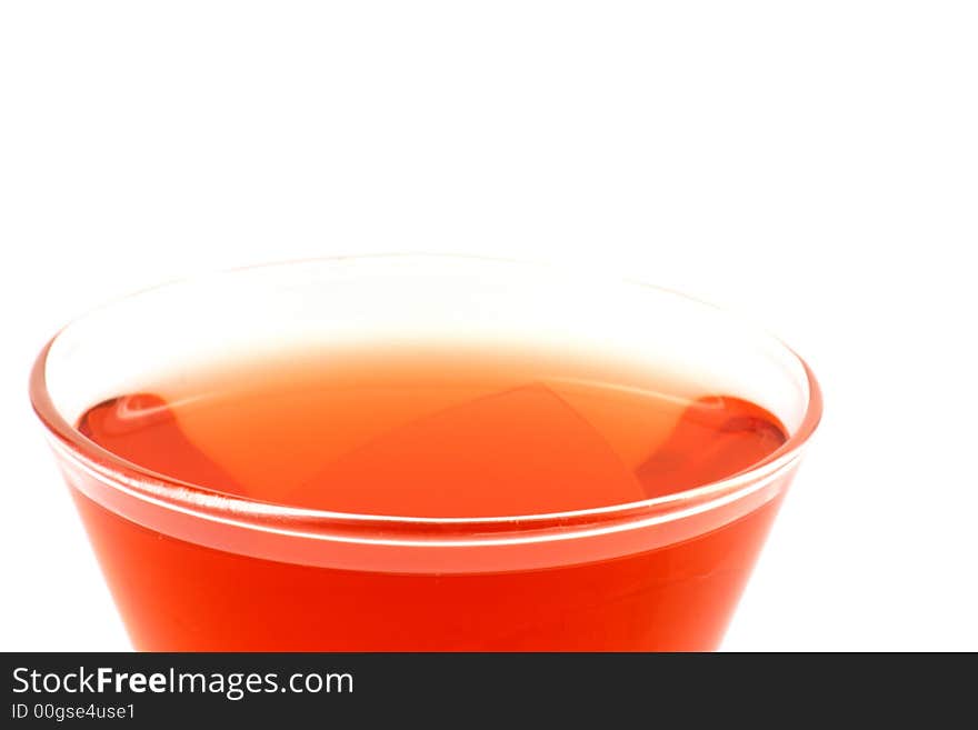 Close up at vivid red drink on a white background. Close up at vivid red drink on a white background