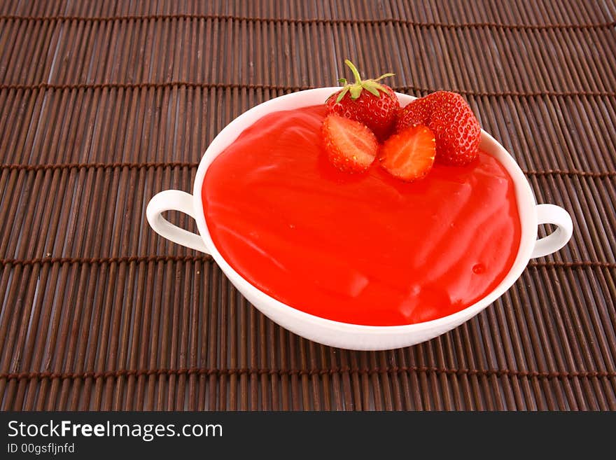 Strawberry jelly with mint leaf as garnish. Strawberry jelly with mint leaf as garnish