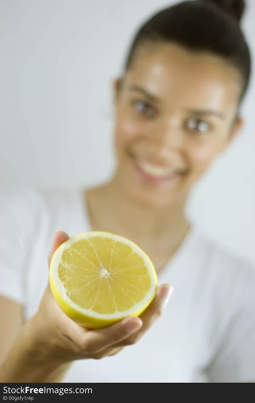 Smiling girl holding piece of citrus. Smiling girl holding piece of citrus