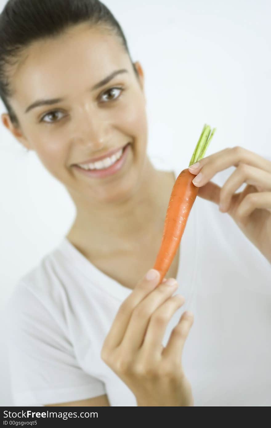 Girl holding carrot with her hands. Girl holding carrot with her hands