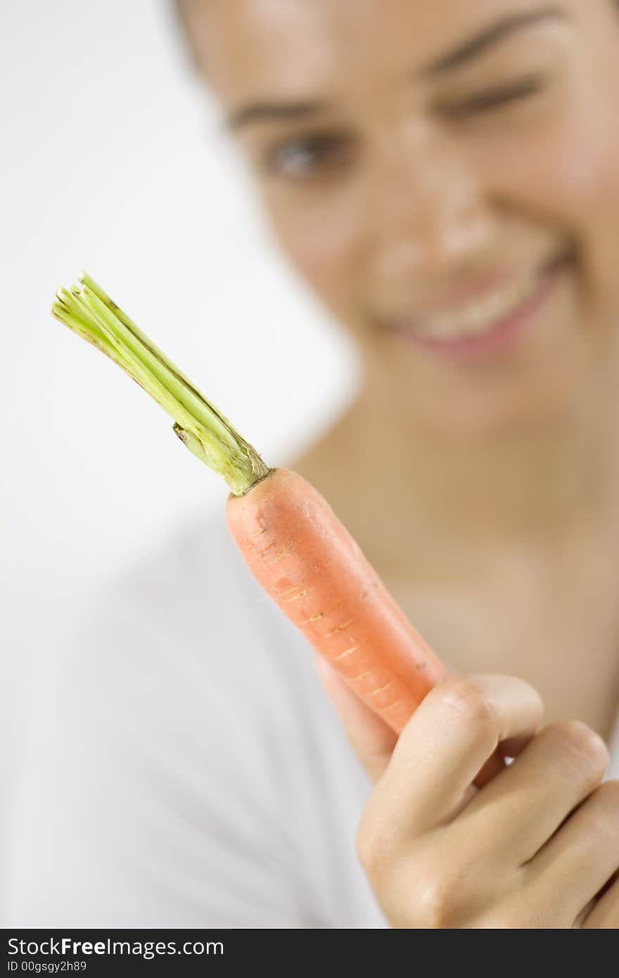 Girl holding carrot with her hand. Girl holding carrot with her hand