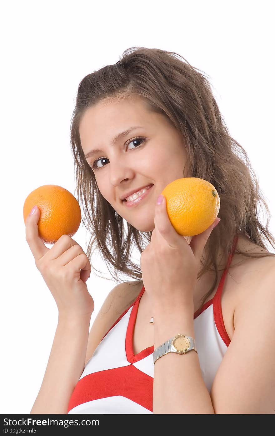 The brown-eyed girl on a white background holds oranges. The brown-eyed girl on a white background holds oranges