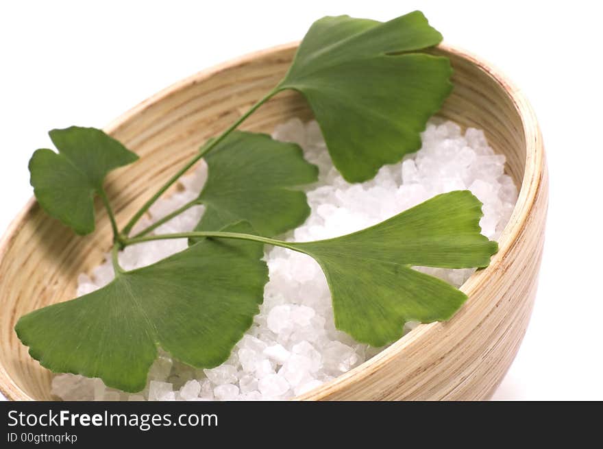 Ginkgo biloba branch and bath salt isolated on the white background. Ginkgo biloba branch and bath salt isolated on the white background