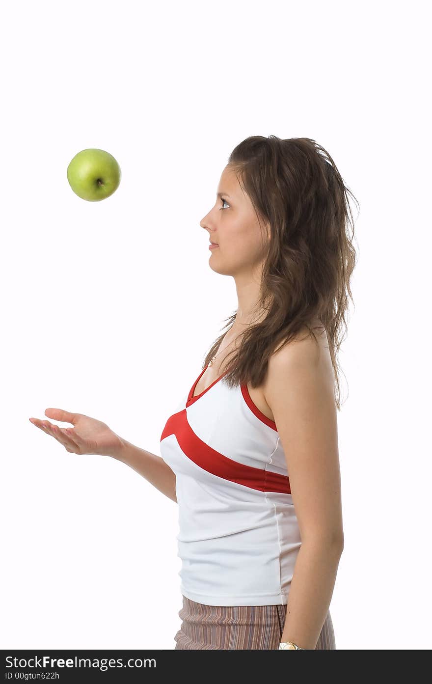 The brown-eyed girl holds a green apple. The brown-eyed girl holds a green apple.