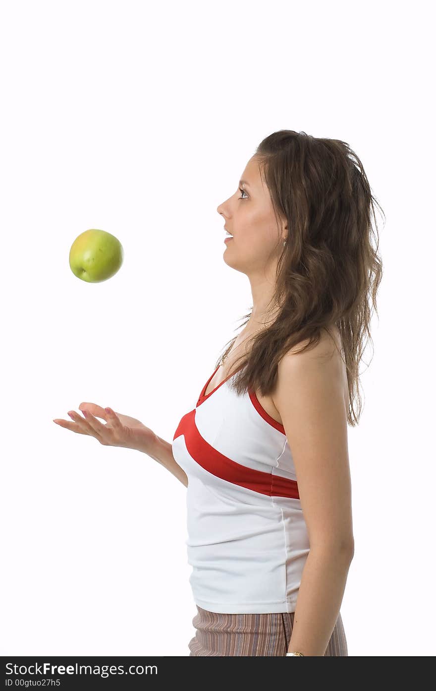 The brown-eyed girl holds a green apple. The brown-eyed girl holds a green apple.