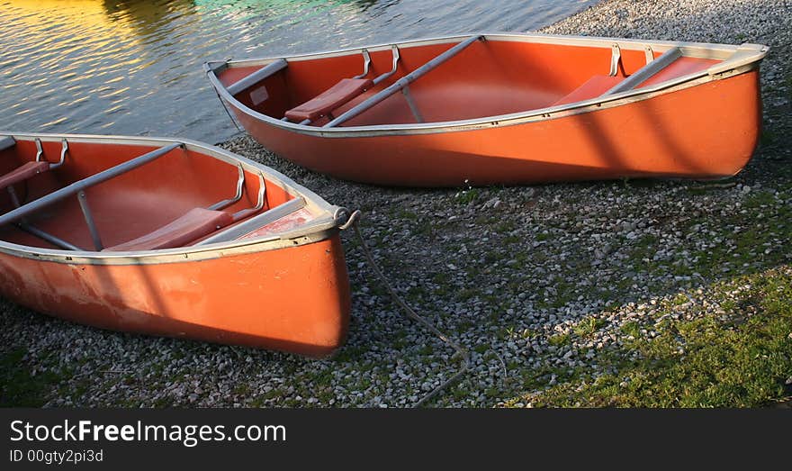 Canoes on the river bank lit with the morning light. Canoes on the river bank lit with the morning light