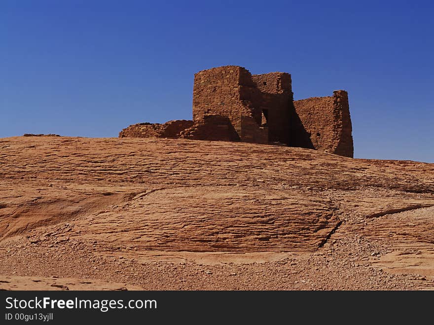 The red rocks on the Wukoki indian pueblo ruins against a blue Arizona sky in Wupatki National Monument