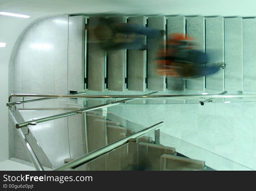 Persons in a staircase walking downstairs