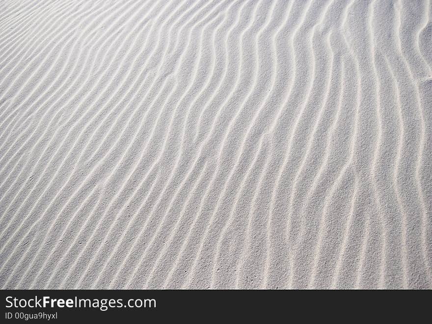 windy pattern on the white sand on the desert. windy pattern on the white sand on the desert