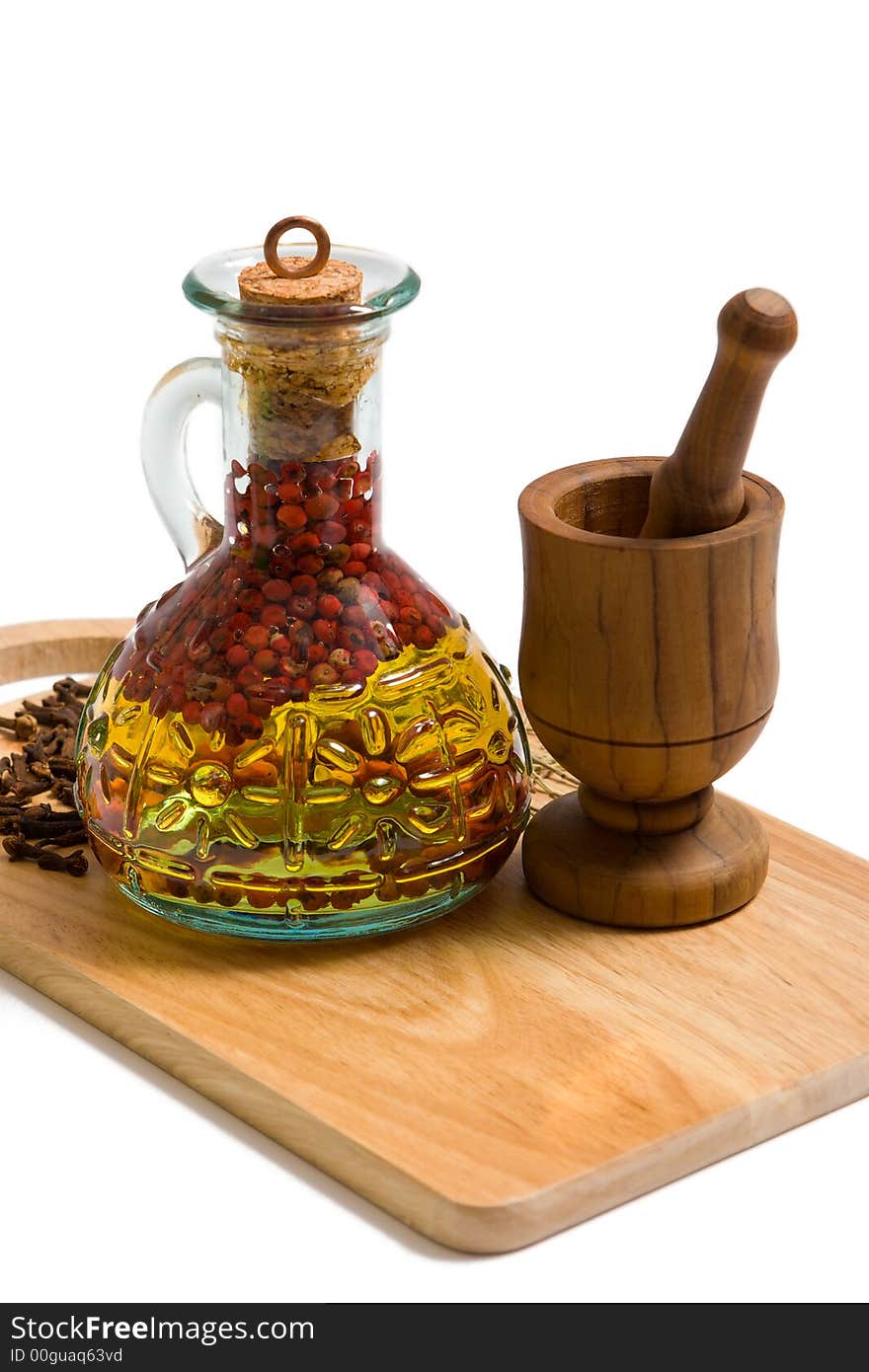 Bottle of olive oil  and vessel on cutting board. Bottle of olive oil  and vessel on cutting board.