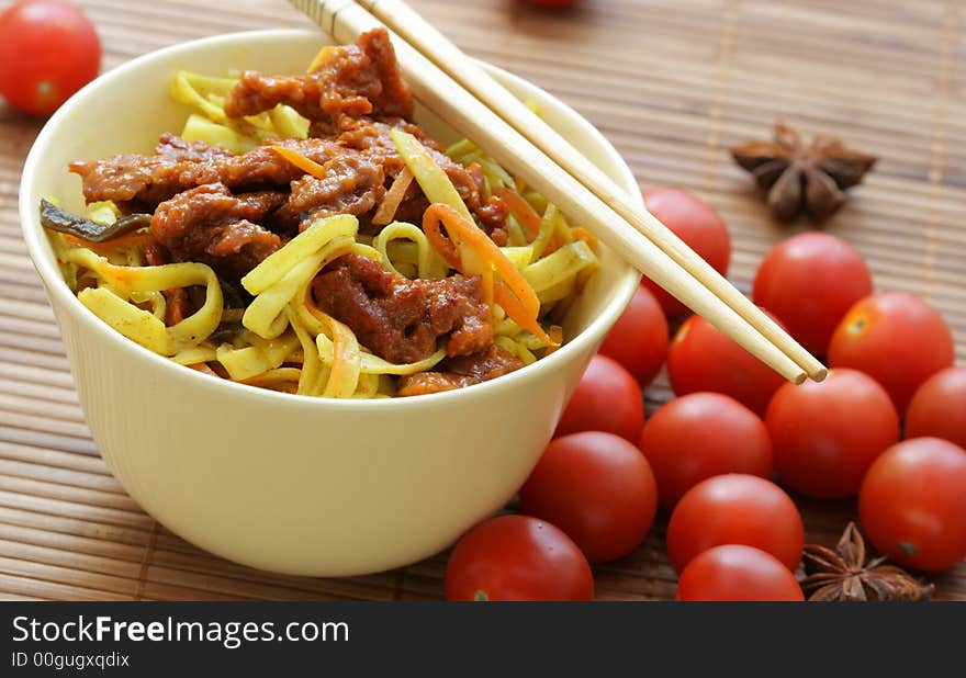 Chinese noodles and fried beef within bowl close-up. Chinese noodles and fried beef within bowl close-up