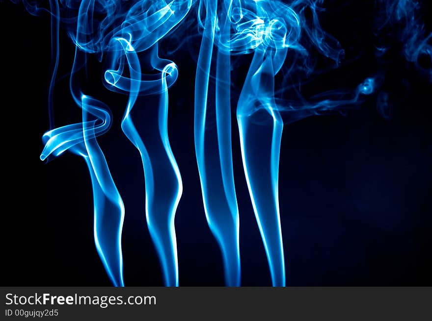 Light blue smoke waves over black background