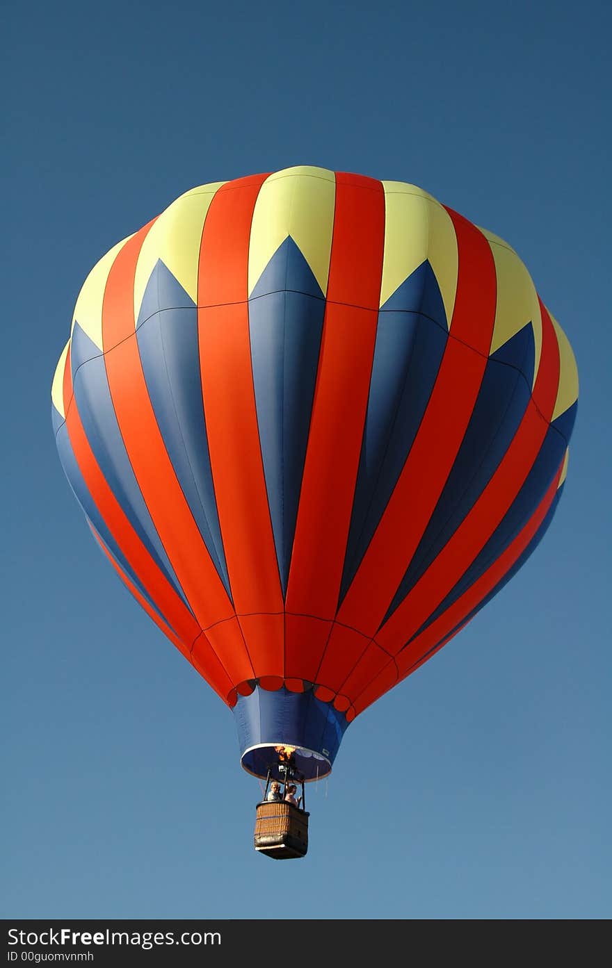 Colorful hot air balloon floating in the blue summer sky