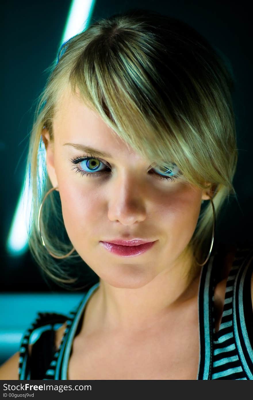 Young woman portrait on a dark background.