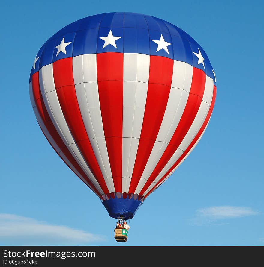 Colorful hot air balloon floating in the blue summer sky