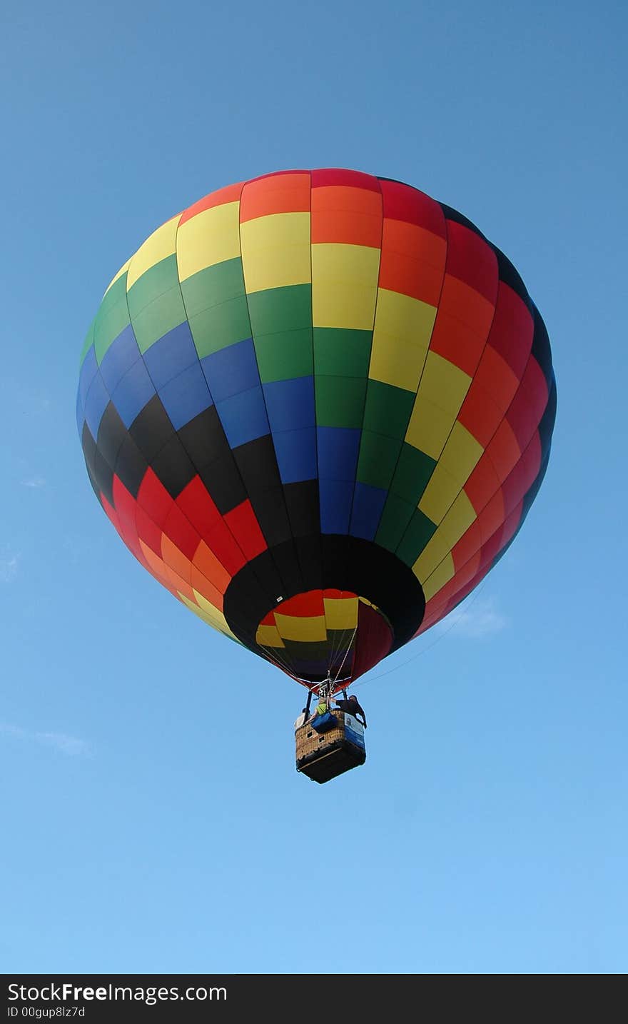 Colorful hot air balloon floating in the blue summer sky