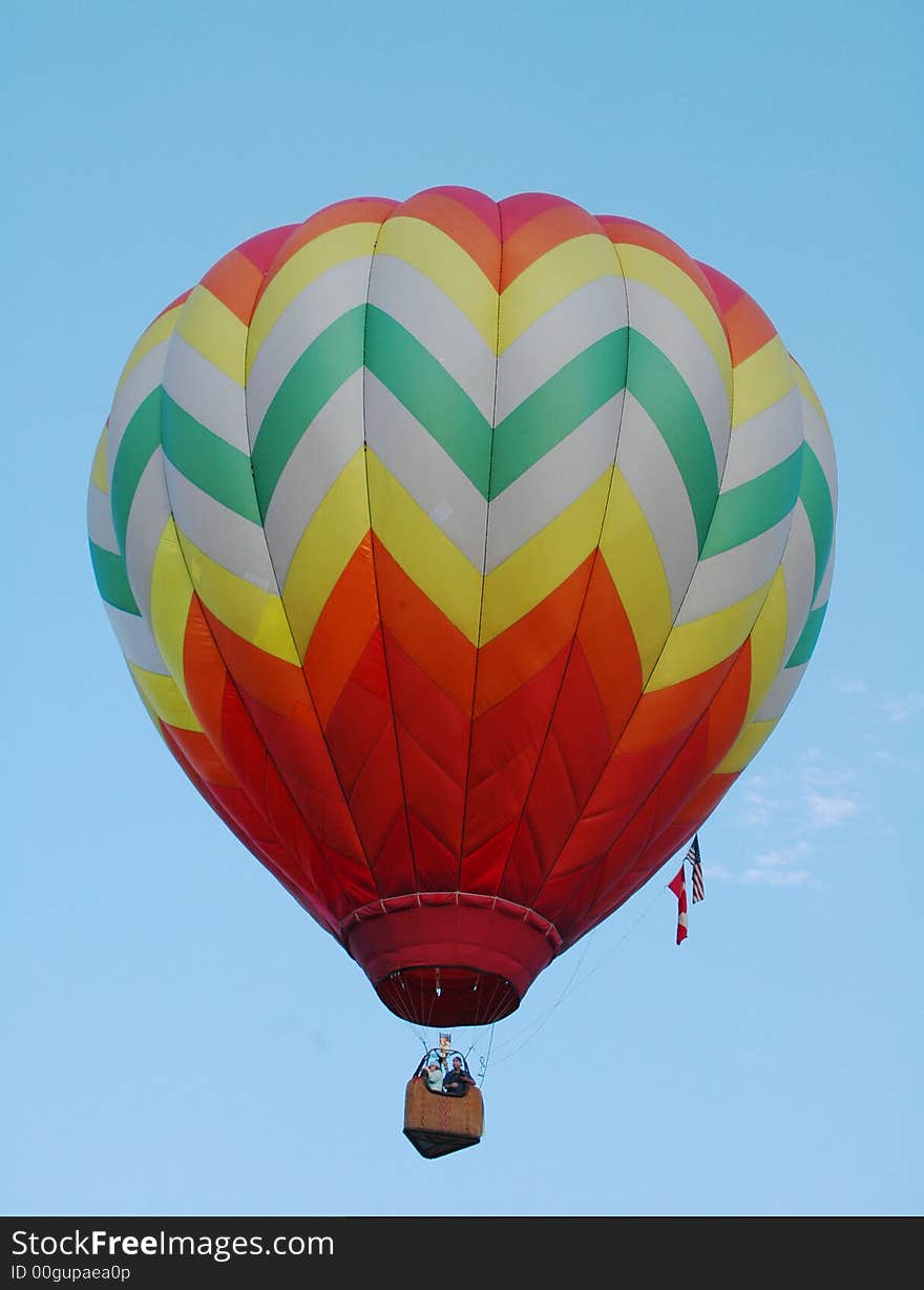 Colorful hot air balloon floating in the blue summer sky