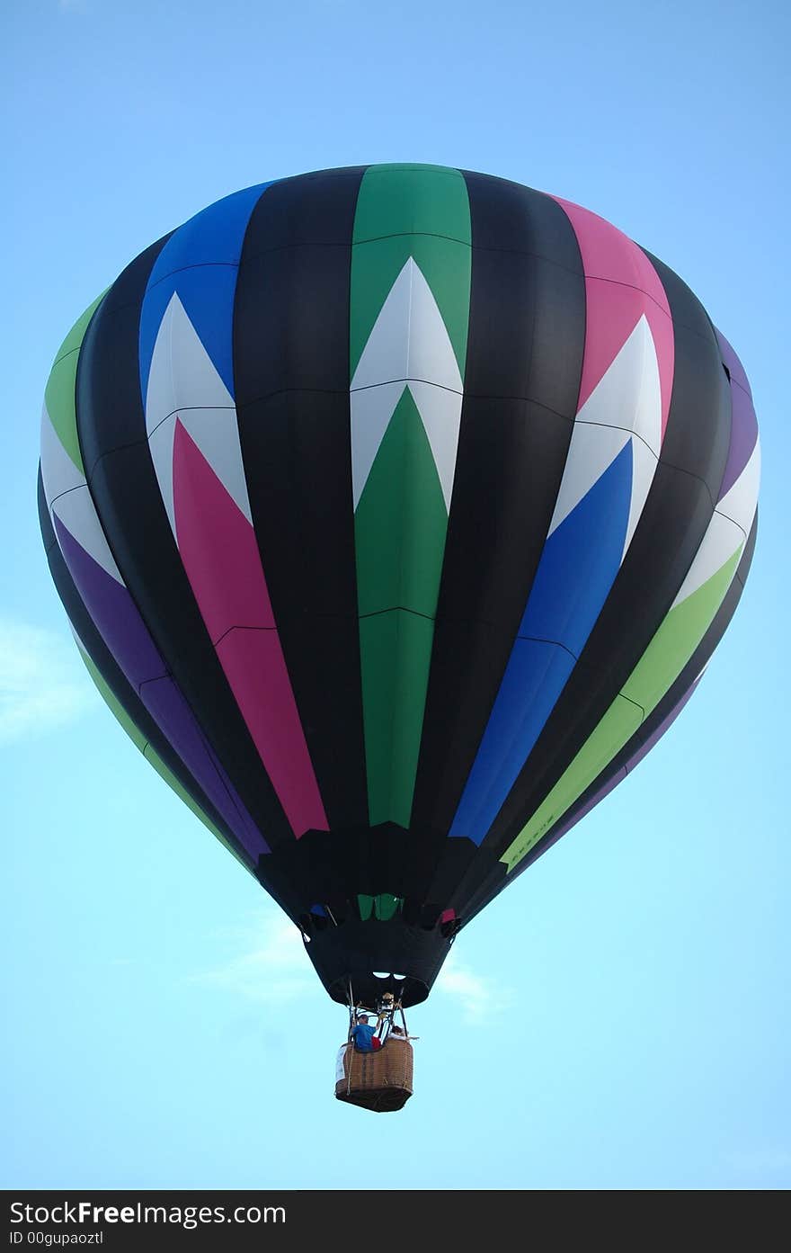 Colorful hot air balloon floating in the blue summer sky