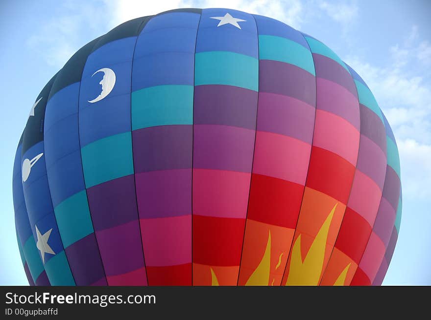 Closeup of colorful hot air balloon against  the blue summer sky