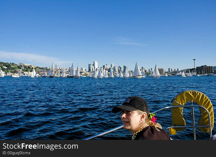 Sailboat crew member with downtown Seattle and sailboats