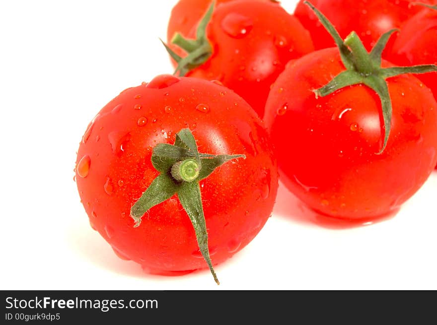 Wet tomatoes on white background