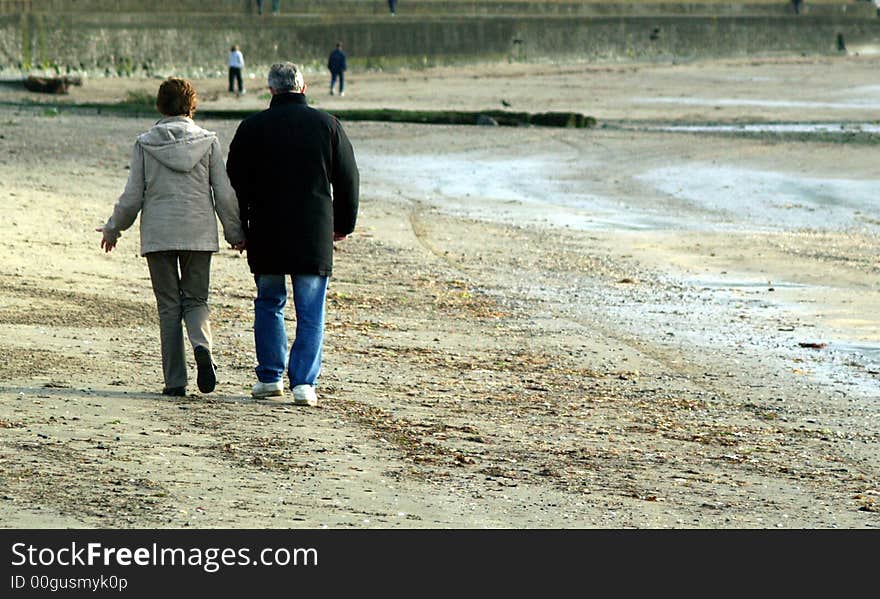 Older couple on beach holding hands. Older couple on beach holding hands