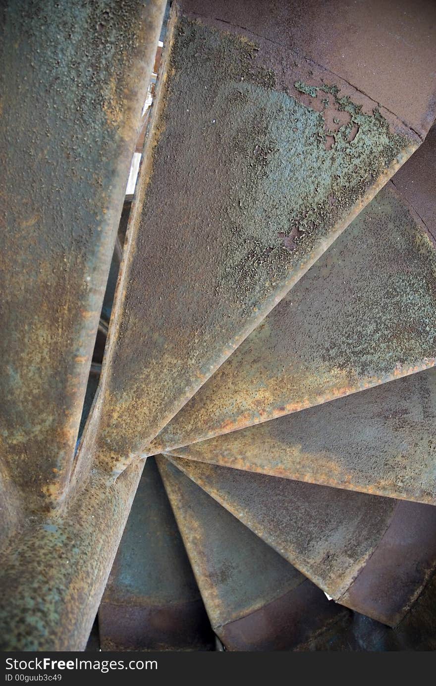 Old rusty spiral fire escape stairs. Old rusty spiral fire escape stairs