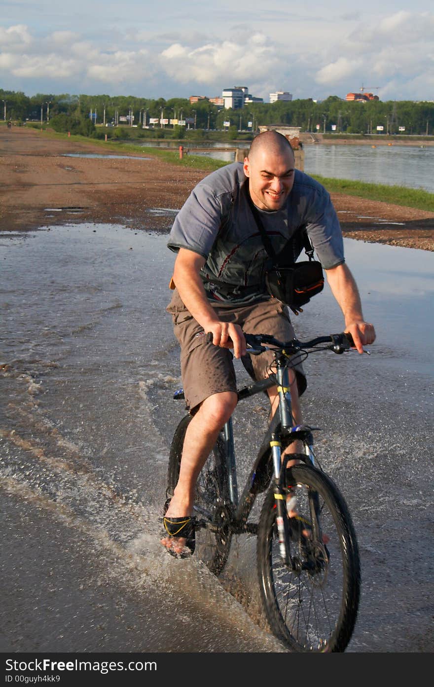 Man on the bike crossing the water. Man on the bike crossing the water