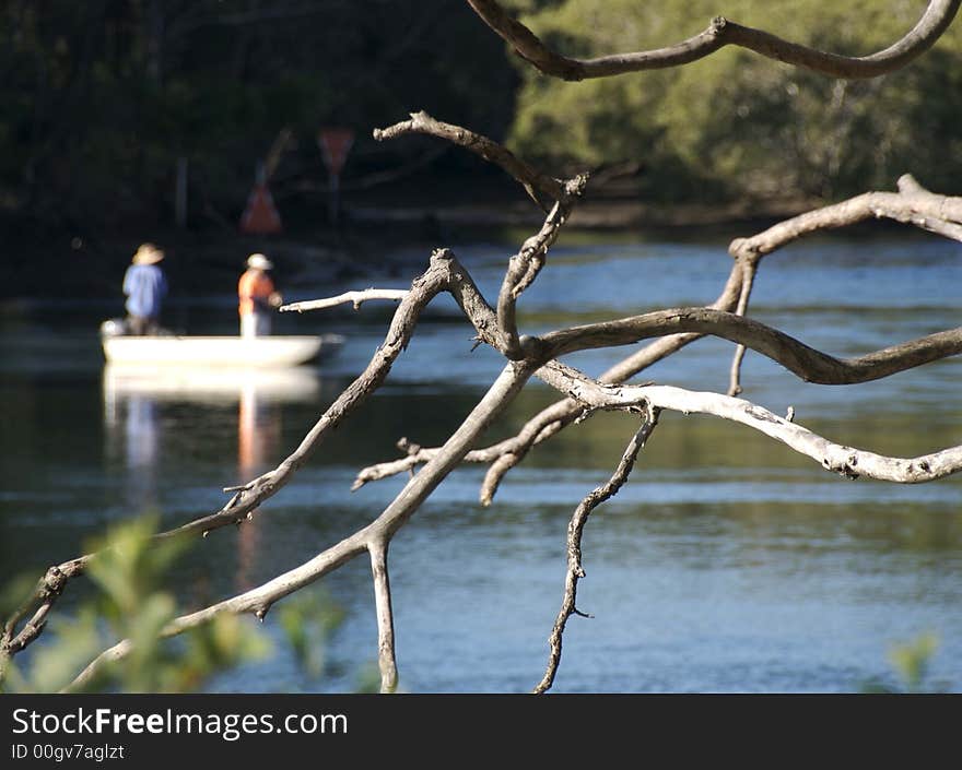 Fisherman in a boat on a river. Fisherman in a boat on a river