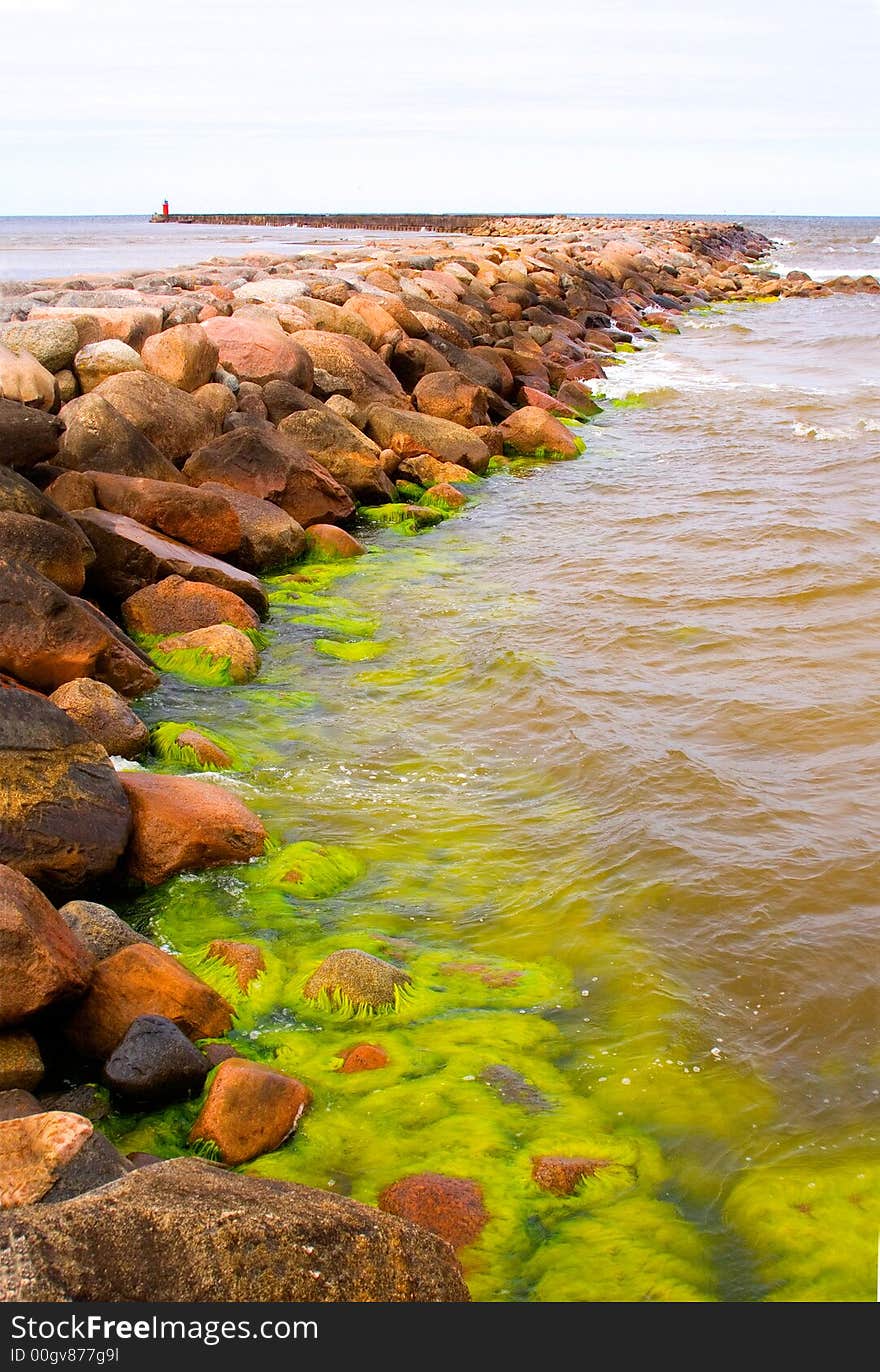 Artificial breakwater of big stones in a harbor