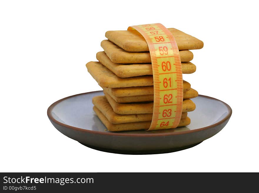 Cookies on plate with measure tape, isolated.